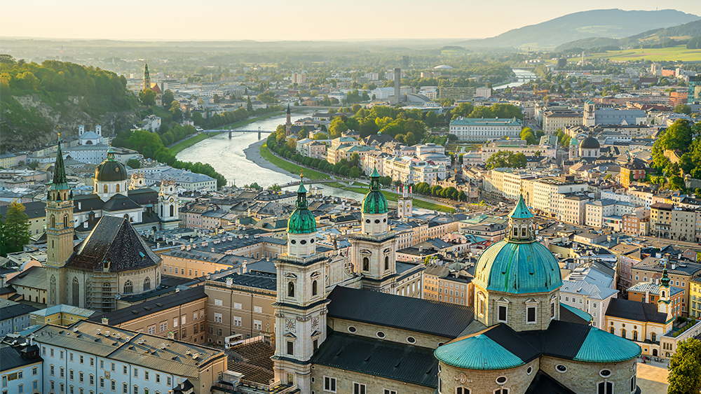 The view of the old town of Salzburg from Hohensalzburg fortress, with its baroque buildings like Salzburg cathedral and Franziskanerkirche, in the backround is the Salzach river